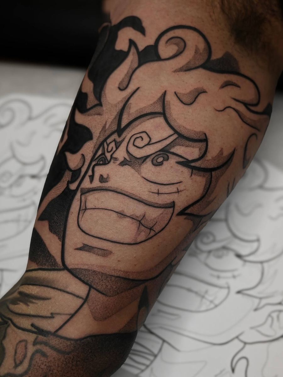 Gear 5 Luffy tattoo, One Piece character with curled horns and open-mouth roar by Wade Whitman — Madison Heights MI tattoo artist