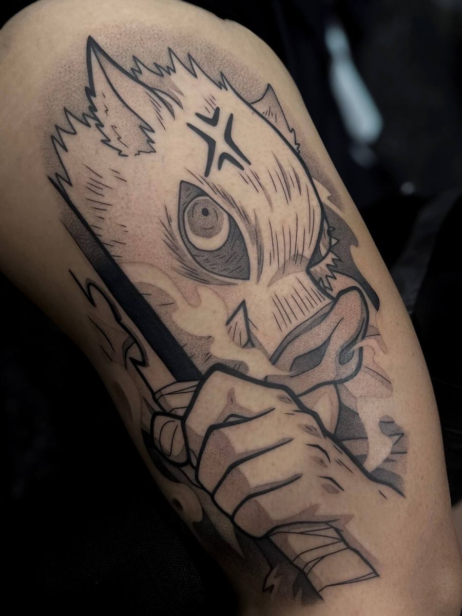 Inosuke tattoo, Demon Slayer character skull-mask portrait gripping a blade by Wade Whitman — Madison Heights MI tattoo artist