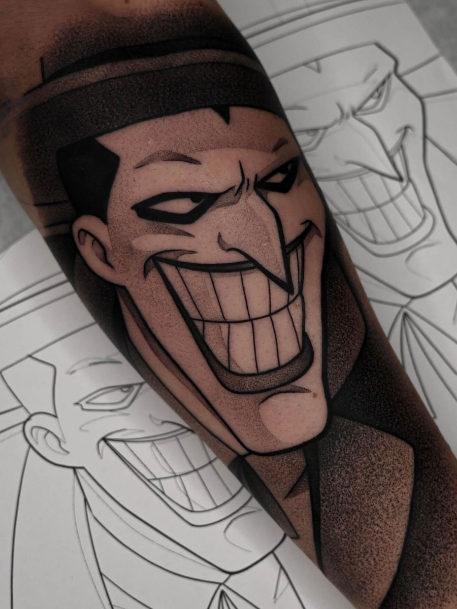 The Joker tattoo, Batman Animated Series character with wide grin and dark markings by Wade Whitman — Madison Heights MI tattoo artist
