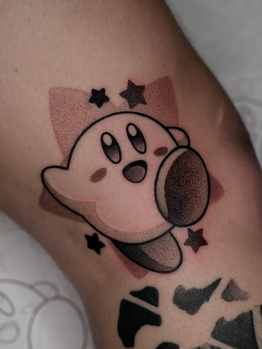 Kirby tattoo, pink Nintendo character with stars and patterned background by Wade Whitman — Madison Heights MI tattoo artist