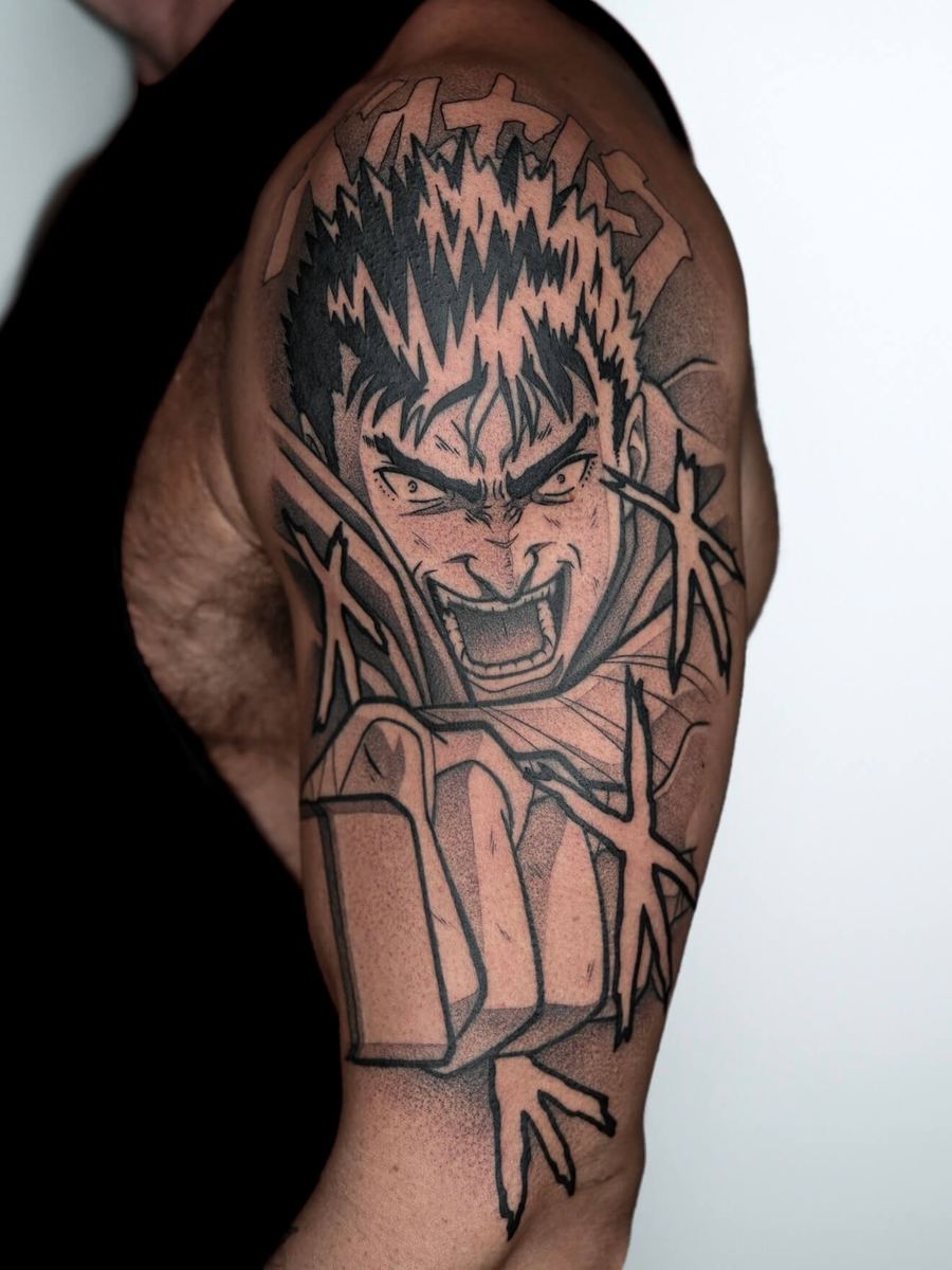 Guts tattoo, Berserk character bicep portrait with spiky hair and bared teeth by Wade Whitman — Madison Heights MI tattoo artist