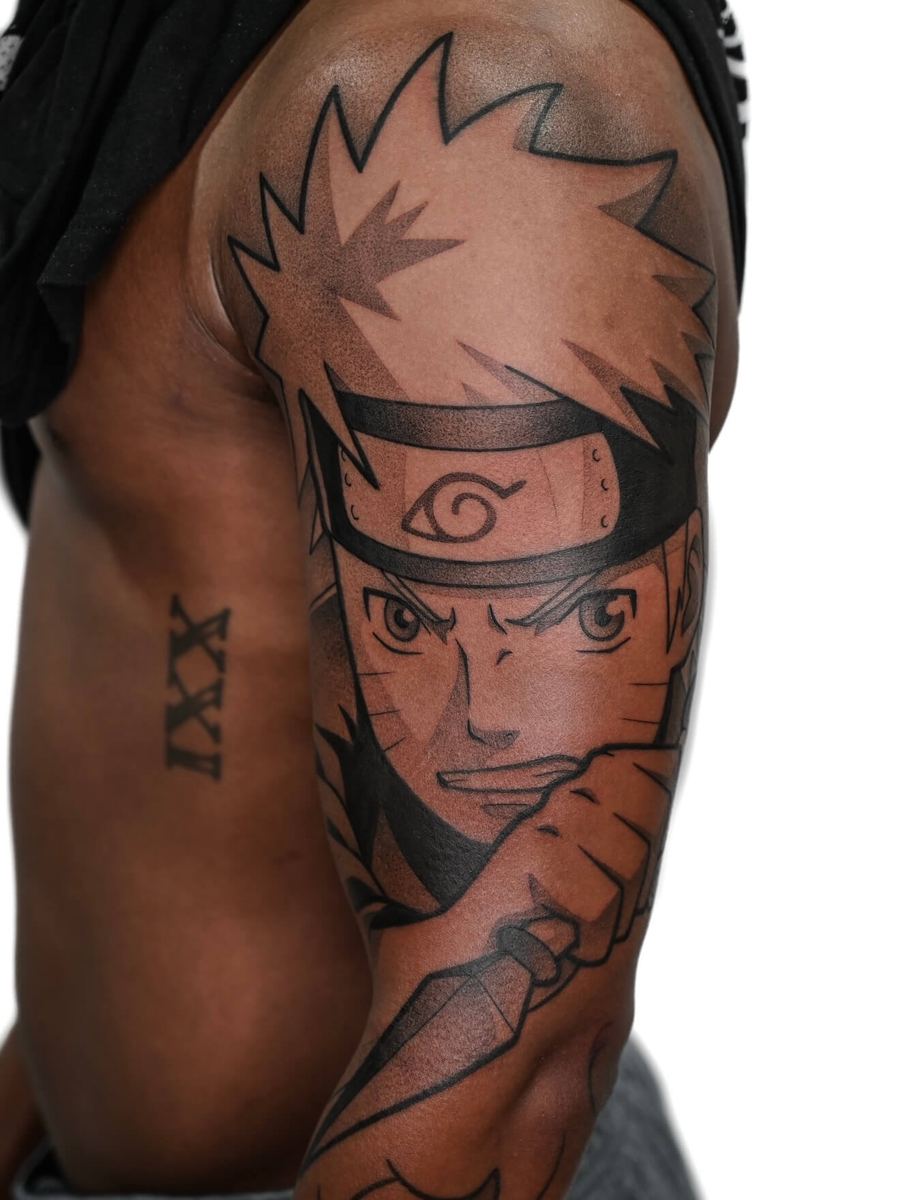 Naruto tattoo, Naruto Shippuden character outer bicep portrait with headband by Wade Whitman — Madison Heights MI tattoo artist