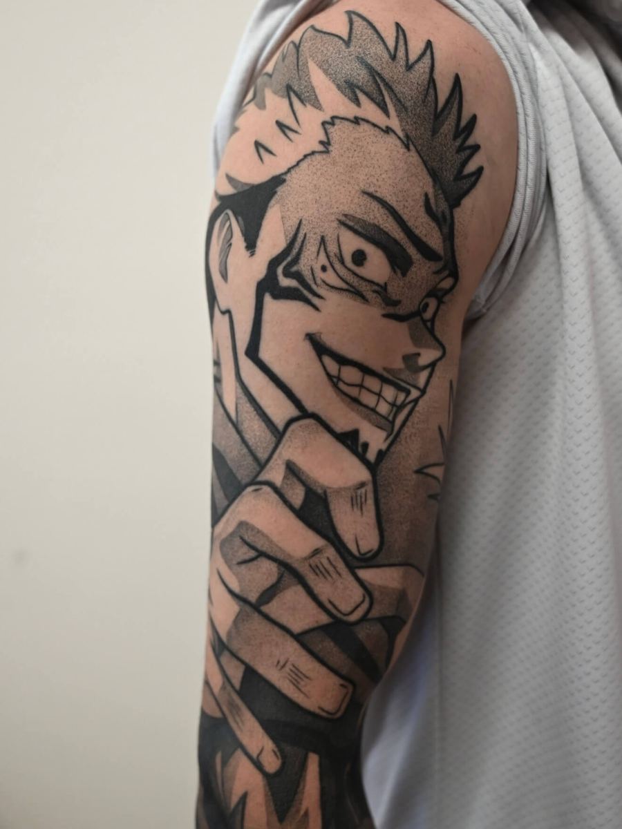 Ryomen Sukuna tattoo, Jujutsu Kaisen character with wide grin and spiked dark hair by Wade Whitman — Madison Heights MI tattoo artist