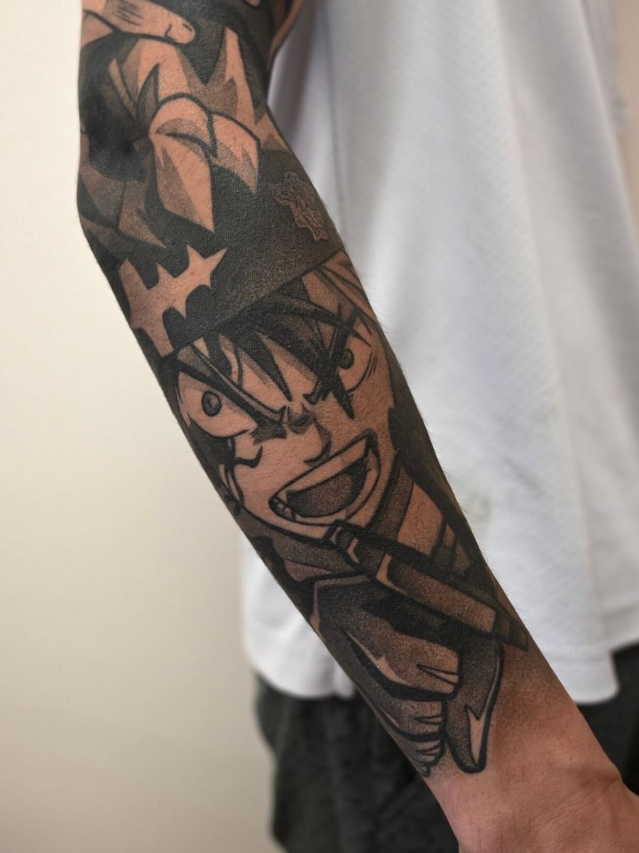 Asta tattoo, Black Clover character with dark spiky hair, dynamic arm-raised pose by Wade Whitman — Madison Heights MI tattoo artist